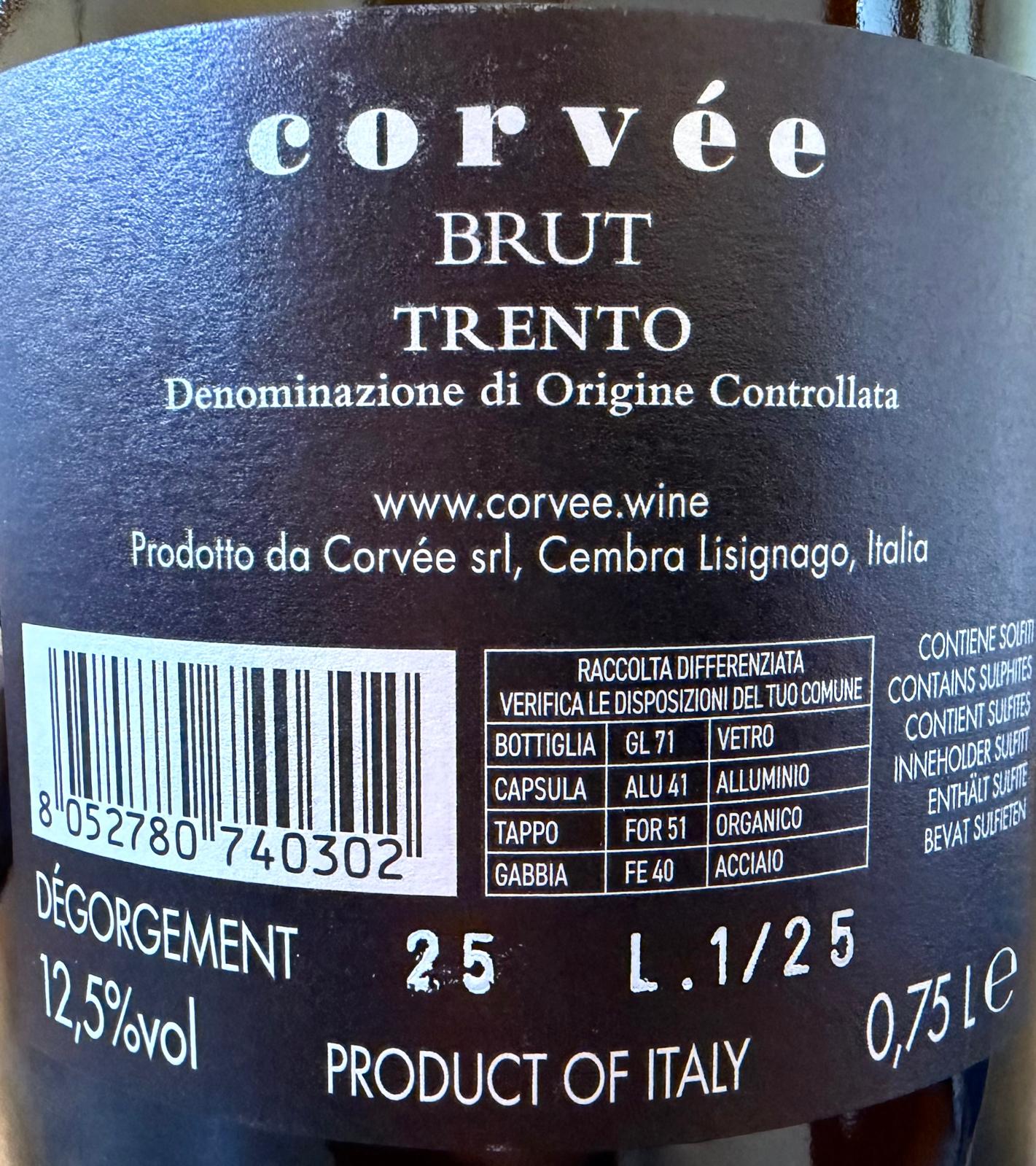 Close-up of a dark black wine label for Corvèe Brut Trento DOC, showing product details, barcode, alcohol content, and production information in Italian.