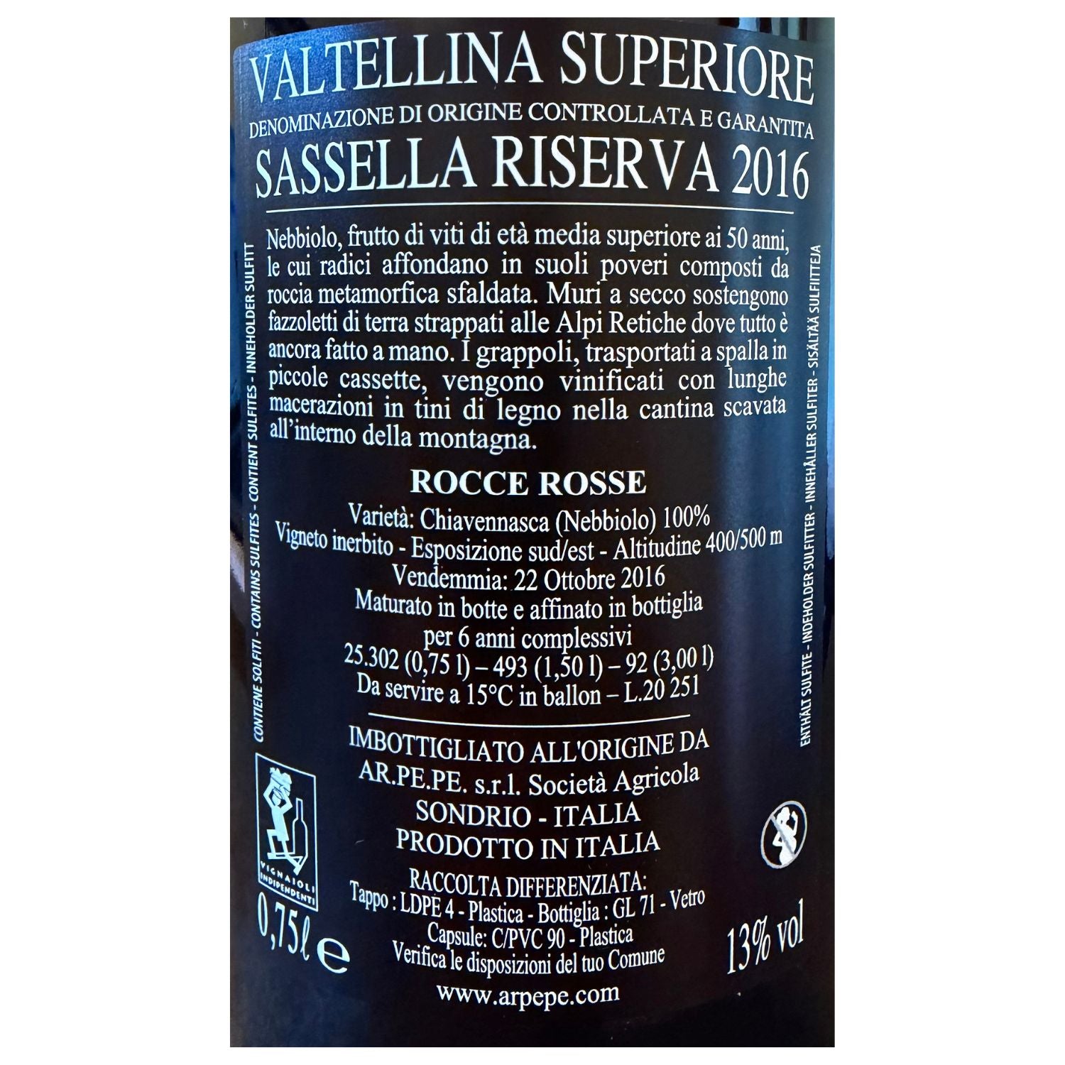 A close-up of a wine label for Valtellina Superiore Sassella Riserva 2016, with white text and the red 'Rocce Rosse' name near the bottom.