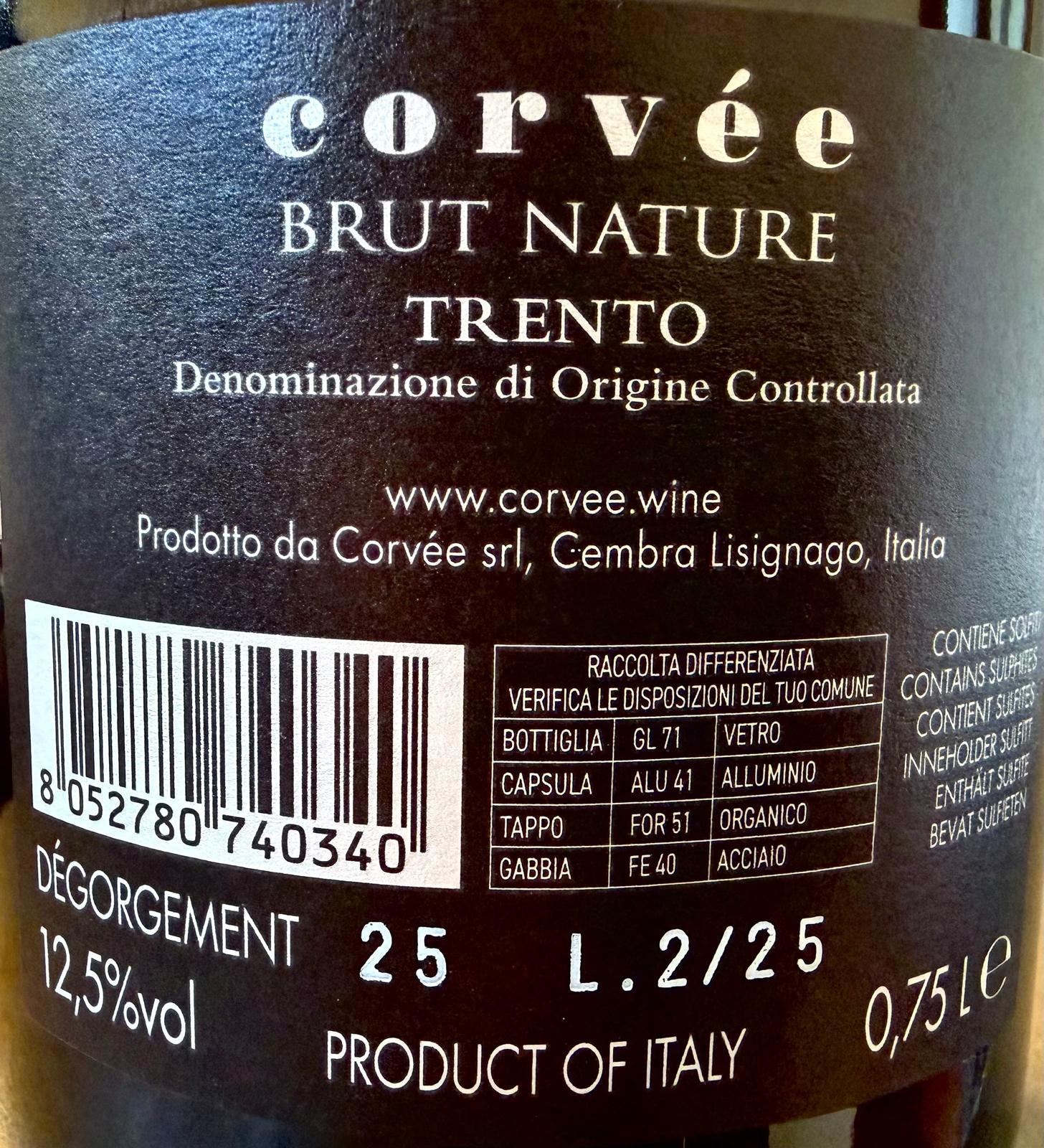 Close-up of a wine label for Corvèe Brut Nature Trento, showing white text, a barcode, and product details in Italian.