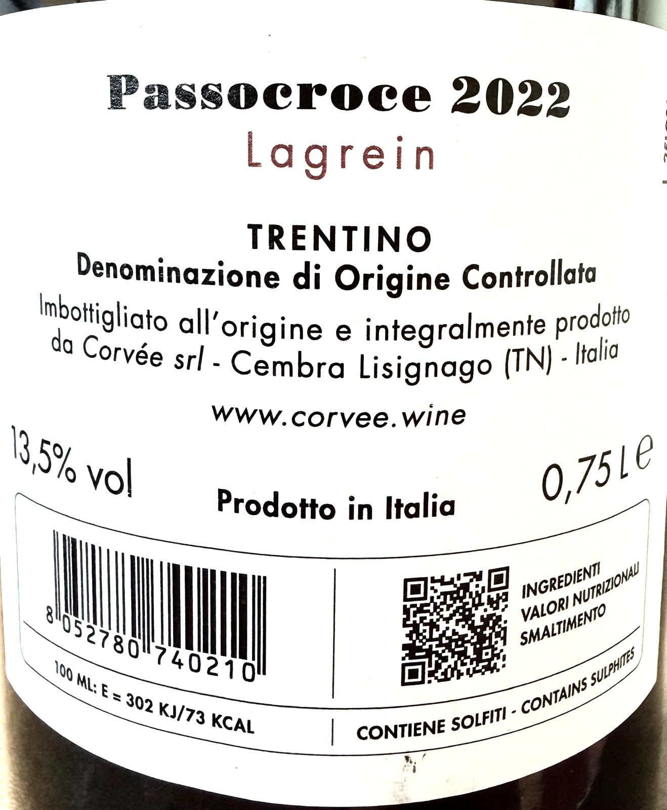 Close-up of a white wine label reading 'Passocroce 2022 Lagrein' with Trentino text, a barcode, QR code, and website www.corvee.